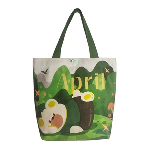 Canvas tote bag with cute cartoon bear, green handles, and April text illustration