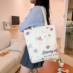 Chic beige canvas tote bag with colorful starry sky planet print and art lettering