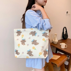 Cartoon canvas tote bag with bear and sunflower prints and brown woven shoulder strap
