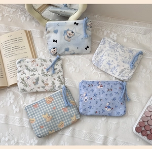 Close-up showing various patterns and zipper details of five cotton mini coin purses
