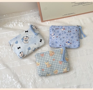Detail of mini cotton coin purses with cute cartoon patterns and soft woven zipper pulls
