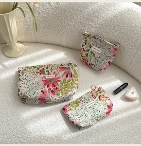 Detailed set of three floral canvas cosmetic bags with vintage embroidery and zipper