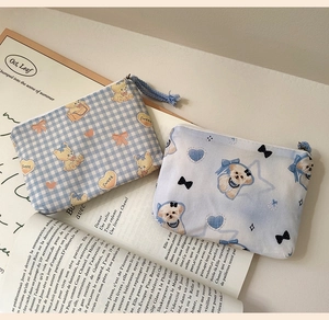 Close-up of cute cartoon cotton mini coin purses for earphones and lipstick storage