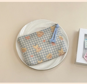 Detail of blue gingham cotton pouch with cute cartoon bears and zipper pull cord