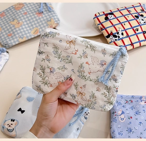 Close-up of cute cartoon cotton coin purse with zipper closure and woven handle