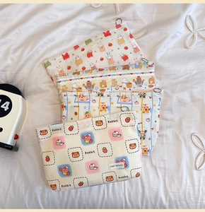 Detail view of cute cartoon canvas storage bags with rabbits and bear prints