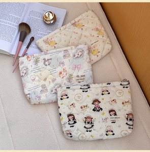Detail of three quilted cotton makeup bags with cute prints and zipper closure