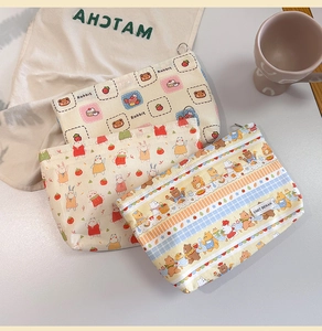 Detailed view of cute cartoon makeup bags in various styles with smooth zipper closure