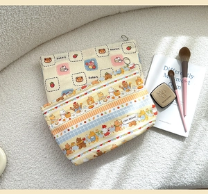 Macro detail of cartoon canvas makeup bags with cute bear and rabbit floral prints