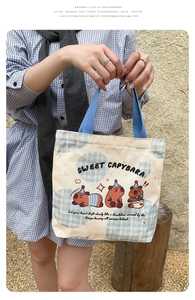 Detailed view of Capybara canvas tote bag with blue handles and cartoon print