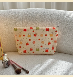 Detail of cute cartoon cosmetic bag with rabbit prints and zipper on soft fleece background