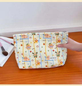 Detail showing canvas makeup bag with cartoon animal patterns and a durable zipper closure