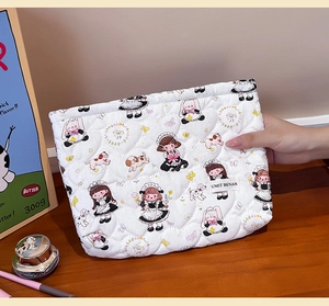 Detail of white quilted cosmetic bag with heart stitching and cute girl and animal prints