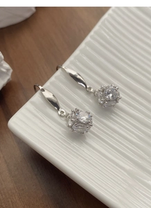 Close-up of S925 sterling silver hook earrings with cubic zirconia sphere pendants