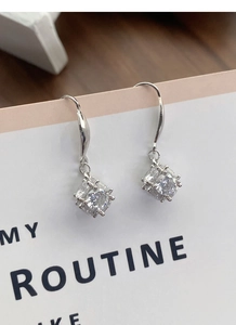 Macro shot of S925 sterling silver hook earrings featuring square-cut cubic zirconia