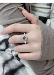 Macro view of adjustable S925 silver pearl ring featuring blue cat eye stone and pavé gems