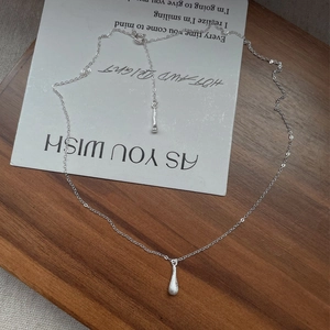 Minimalist S925 silver necklace featuring a matte brushed teardrop pendant on a tray