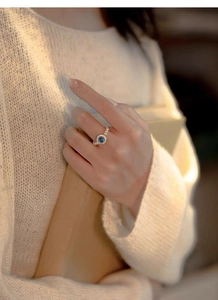 Close-up of S925 sterling silver ring with aquamarine gemstone and white pearls on hand