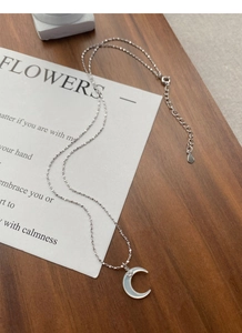 Close-up of S925 silver crescent moon necklace with white mother of pearl and small zircon