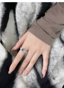 Close-up of S925 silver ring with aquamarine stone and pearls worn on the finger