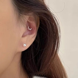 Minimalist S999 sterling silver croissant stud earrings and pearl ear cuff on female model