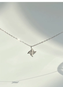 Close-up of S925 sterling silver windmill pendant necklace with sparkling micro diamonds