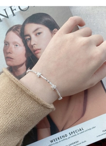 Detailed view of an S925 sterling silver butterfly bracelet worn on a female wrist