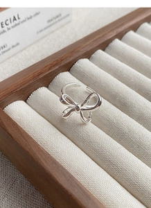 Macro shot of an elegant S925 sterling silver bow ring with polished metallic finish