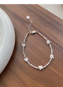 Detail of S925 sterling silver butterfly bracelet with faceted beads and logo tag