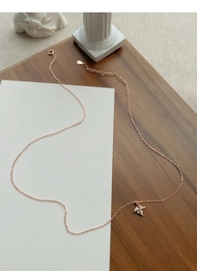 Close-up of S925 sterling silver rose gold windmill necklace with a sparkling zircon stone