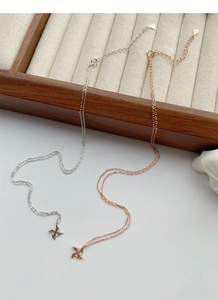 Macro detail of S925 sterling silver windmill pendants in silver and rose gold finishes