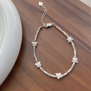 S925 sterling silver butterfly beaded bracelet featuring textured metallic silver charms