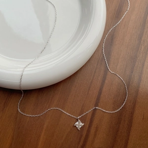 Elegant S925 sterling silver necklace with a minimalist windmill pendant on a white plate