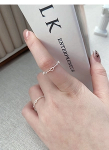 Detail of S925 sterling silver beaded ring featuring a hollow heart on a finger
