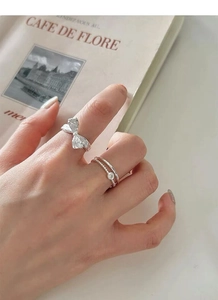 Detail view of S925 sterling silver bow ring and double layered band with crystal