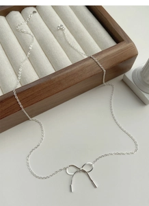 Detail view of S925 silver bow necklace with spliced chain and lobster clasp closure