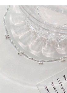 Detailed macro shot of an S925 sterling silver necklace with tiny cherry pendants