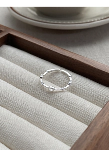 Macro shot of polished S925 sterling silver heart ring with sparkling mini zircons
