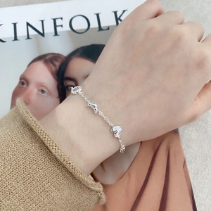 Elegant S925 sterling silver chain bracelet with heart charms worn on a wrist