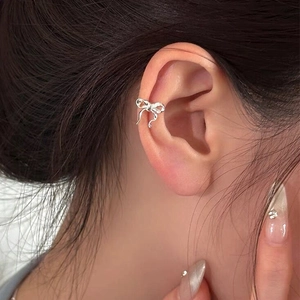 Elegant S925 sterling silver ribbon bow ear cuff on model for a chic and minimal style