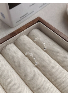 Macro detail of S925 sterling silver hollow heart ring on a minimalist jewelry tray