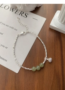 Detail of S925 silver bracelet with lotus pod charm and green nephrite jade beads