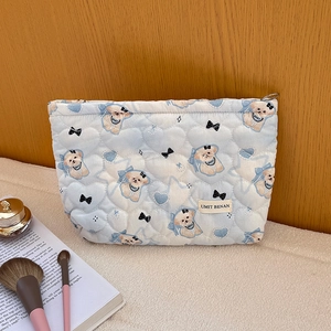 Light blue quilted makeup bag with cute puppy print and heart stitching pattern