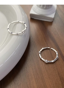 Detailed macro view of S925 sterling silver heart rings with delicate beaded edges