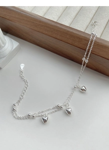 Close-up of S925 sterling silver double-layer heart bracelet with detailed hallmark engraving