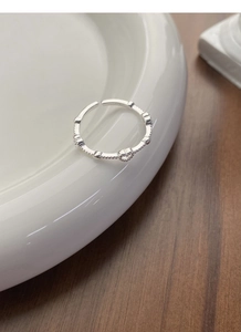Macro shot of S925 sterling silver hollow heart ring with beaded band texture
