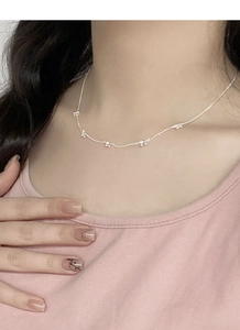 Macro detail of S925 sterling silver chain featuring delicate bead flower clusters on a necklace