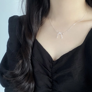 Elegant S925 sterling silver necklace with minimalist bow pendant on female model