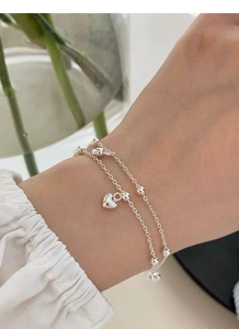 Close-up of S925 sterling silver double-layered heart bracelet worn on a female wrist