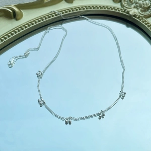 S925 sterling silver cherry-style necklace with bead charms reflected on a blue mirror